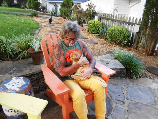 Jeff hugs on our cat Dave. The fur kids are always glad to have us home.