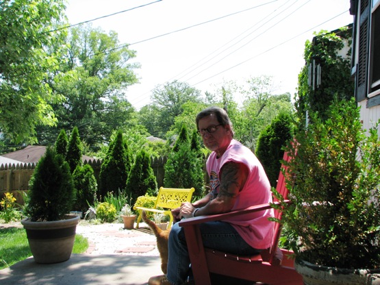 Here's Jeff relaxing in the back yard after the ride. The orange tail belongs to Freddie.