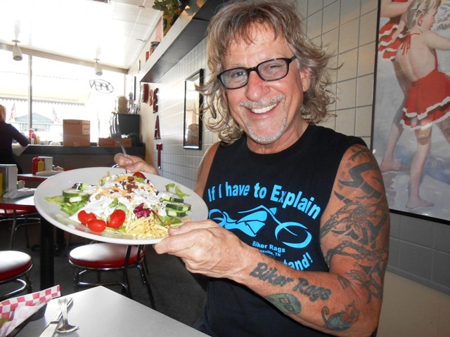 Jeff is laughing about the very LARGE salad he ordered.